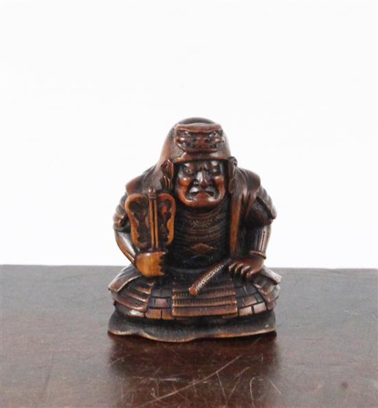 A Japanese boxwood netsuke of a seated Samurai General, late 19th century, 4.5cm